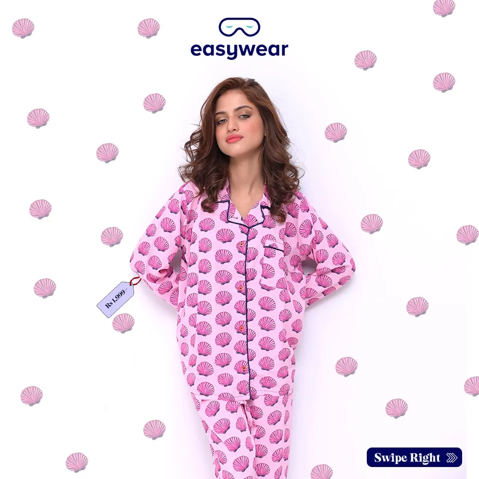 Easywear pyjama set in a pink shell print with a model against a patterned white background